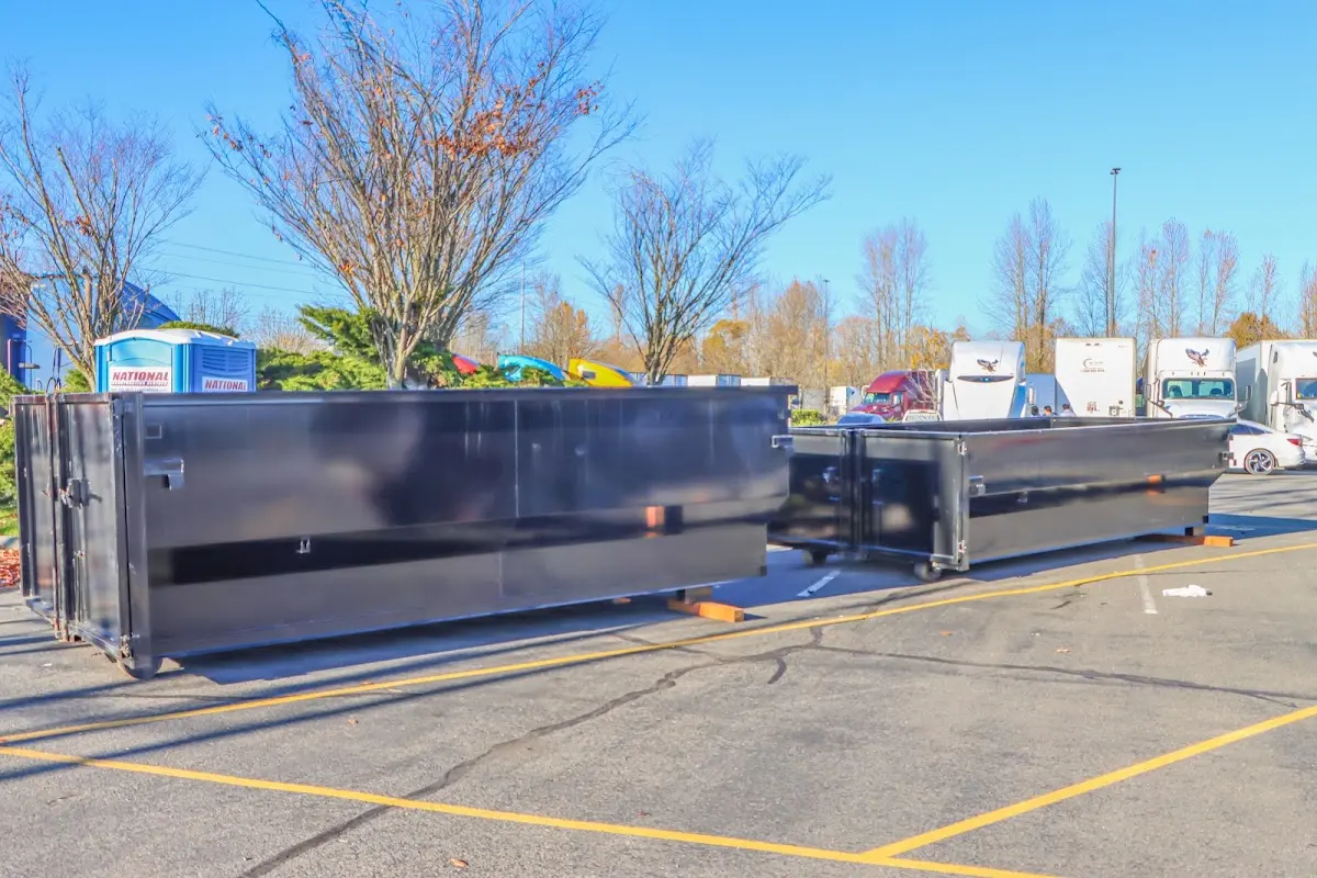 Professional dumpster rental service with roll-off container on residential driveway in Annville